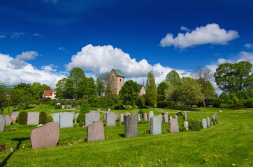 Old sweden church with cemetery in small town near Stockholm - Vallentuna, spring vivid natural outdoor Sweden background