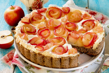 Apple cake with roses, nuts and cream