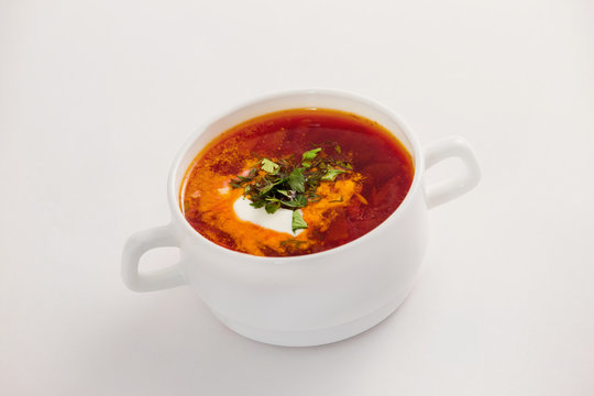 Fresh traditional Ukraine borsh with sour cream in bowl isolated