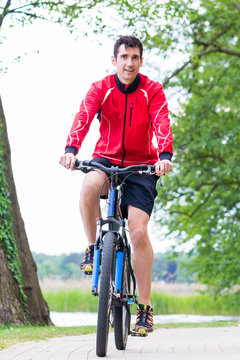 man on mountain bike in the woods cycling