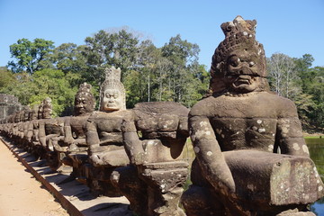 Causeway over a moat leading to the Bayon temple in the ancient city of Angkor Thom, Cambodia