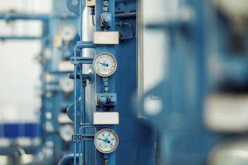 Closeup image of barometers at a brewery industrial plant.