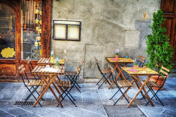 rustic tables and chairs by a trattoria in Florence