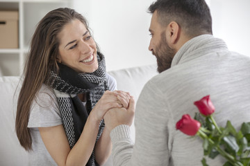 Young man gives a girl flowers for Valentine's Day, shallow depth of field