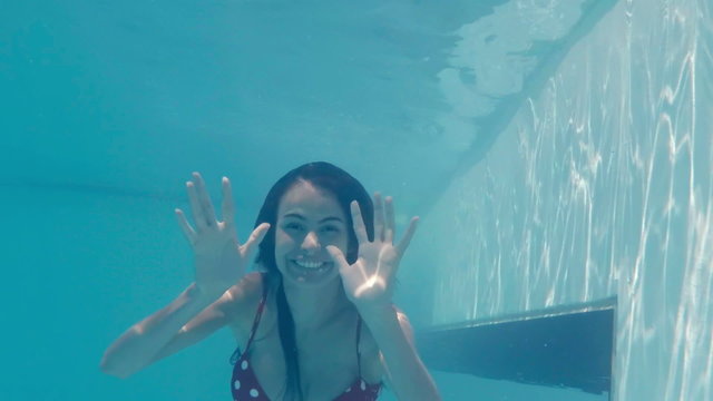 Pretty woman underwater greeting