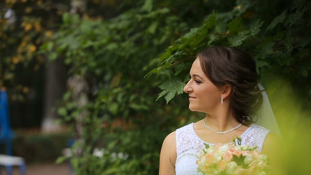 Bride in the wedding dress with bouquet in the park in the summer park. Loving wedding couple outdoor. Bride and groom.Wedding concept. 