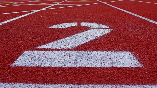 Slow dolly of a number 2 on a running track