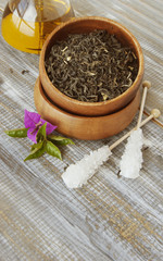 Green tea in a wooden bowl with flowers
