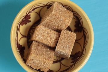 brown sugar in lumps on a ceramic pot
