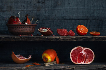Citrus and pomegranate on the shelves, rustic style