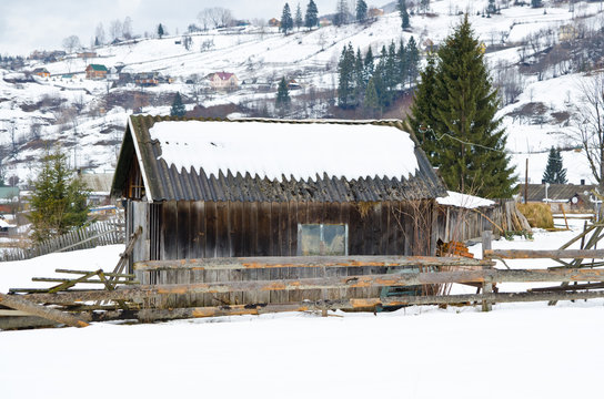 Wooden barn in winter in the countryside