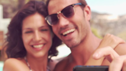 Smiling couple taking a selfie  - Powered by Adobe