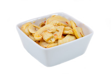 Mushrooms on spicy square bowl on a white background