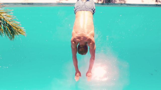 Athletic man diving in the swimming pool