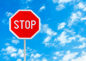 Stop sign against blue sky background