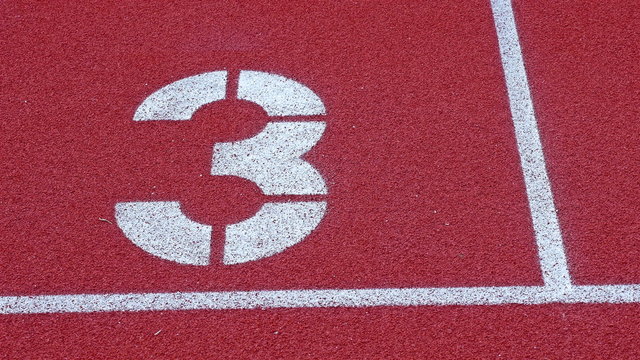Slow dolly of a number 3 on a running track