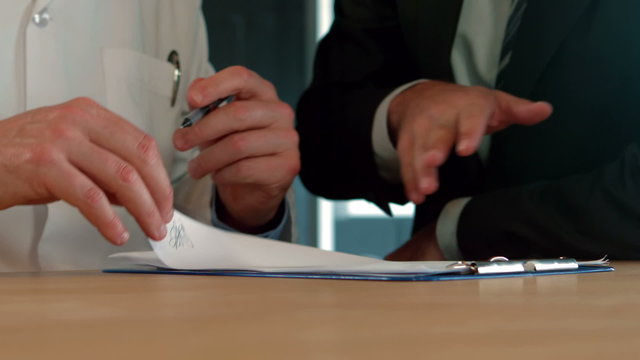 Businessman and doctor signing a agreement