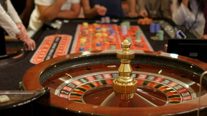 gamble players at casino, gambling roulette poker game table - Powered by Adobe