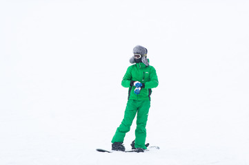 The athlete snowboarder in green overalls