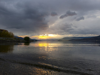 Sun Poking Through The Clouds on Mountain Lake