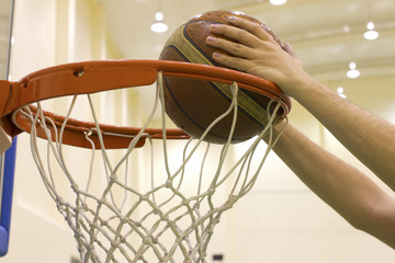 scoring basket in basketball court