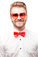 Happy man in heart shaped sunglasses