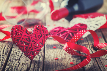 Heart decorated with a red ribbon for a romantic Valentine's day celebration, on vintage wooden background.Toned image.Vintage style.selective focus.