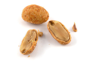 Cracked peanuts on isolated white background