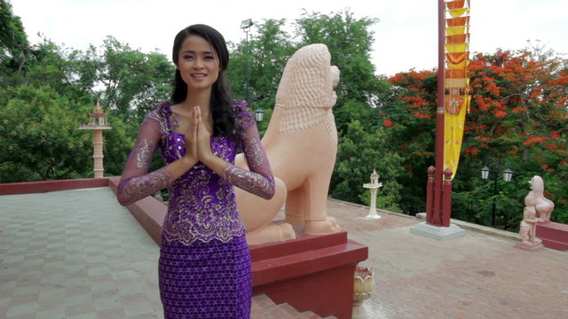 Asian Girl Greets in temple traditional way with both hands