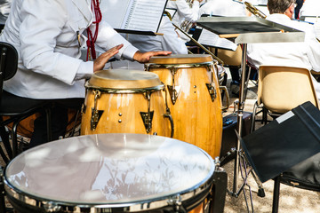 Performance of orchestra in Paris. Close-up hands & drums.