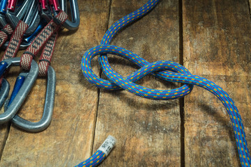 Climbing rope and carabiner on wooden boards