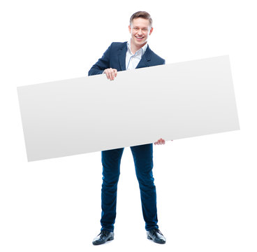 Young business man holding big blank with copy space.
