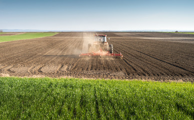 Fototapeta premium Tractor preparing land