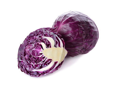 whole and cut fresh red cabbage on white background