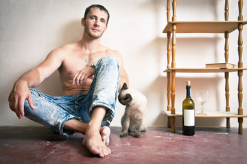 Man with a bottle of wine and cat