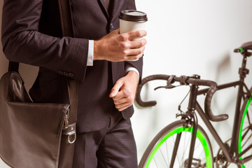 Naklejka premium Young businessman with bicycle