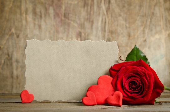 Red rose with paper for text and handemade valentines around on