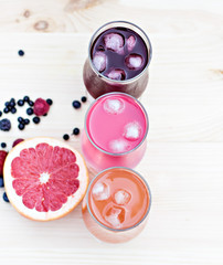 Obraz na płótnie Canvas Fresh colorful lemonade (pink, purple, orange) in glasses