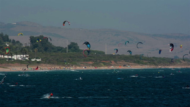 Tarifa, Spain. July 2015. Crow of windsurfers and kitesurfers