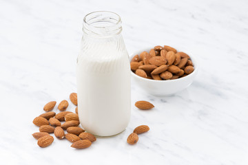 almond milk in a glass bottle on white table