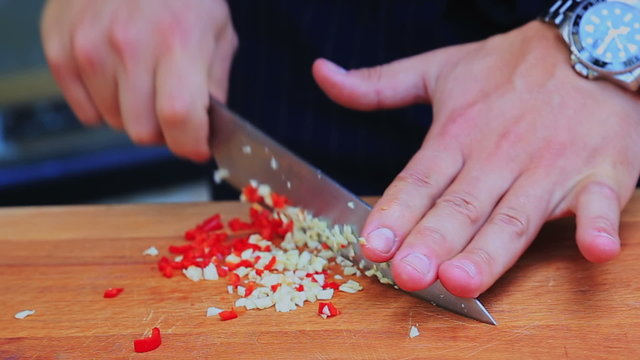 Chopping garlic and chilli peper