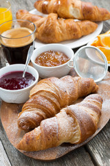 delicious breakfast with fresh croissants on wooden table