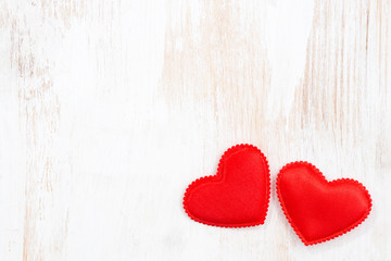 vintage white wooden background with two red hearts