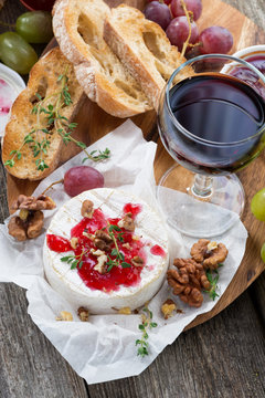 delicious appetizers for wine - camembert, berry jam, toast 
