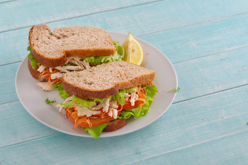 Sandwich with chicken on a wooden background