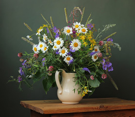 Still life with a bouquet of wild flowers in a white jug. © Masquerade