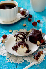 Cottage cheese balls with nuts and chocolate icing on a wooden b