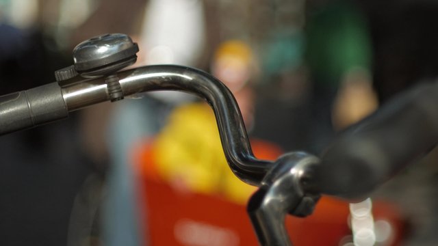 Handlebars of a traditional dutch cycle as cyclists ride past in Amsterdam. Shot in 4K