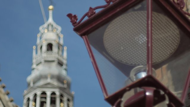 Pull focus from Old Amsterdam streetlamp to the De Oude Kerk. Shot early morning in 4K