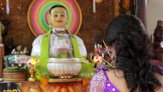 Asian girl praying in temple, wat, pagoda, Phnom Penh, Cambodia